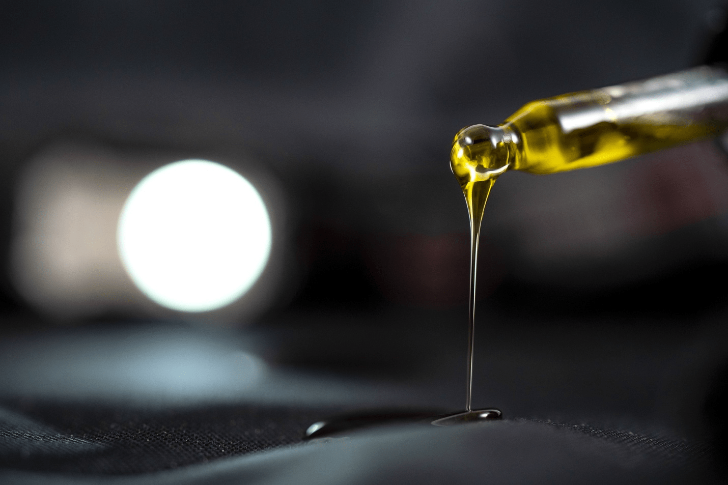 Natural terpene oil dropping from a dripper