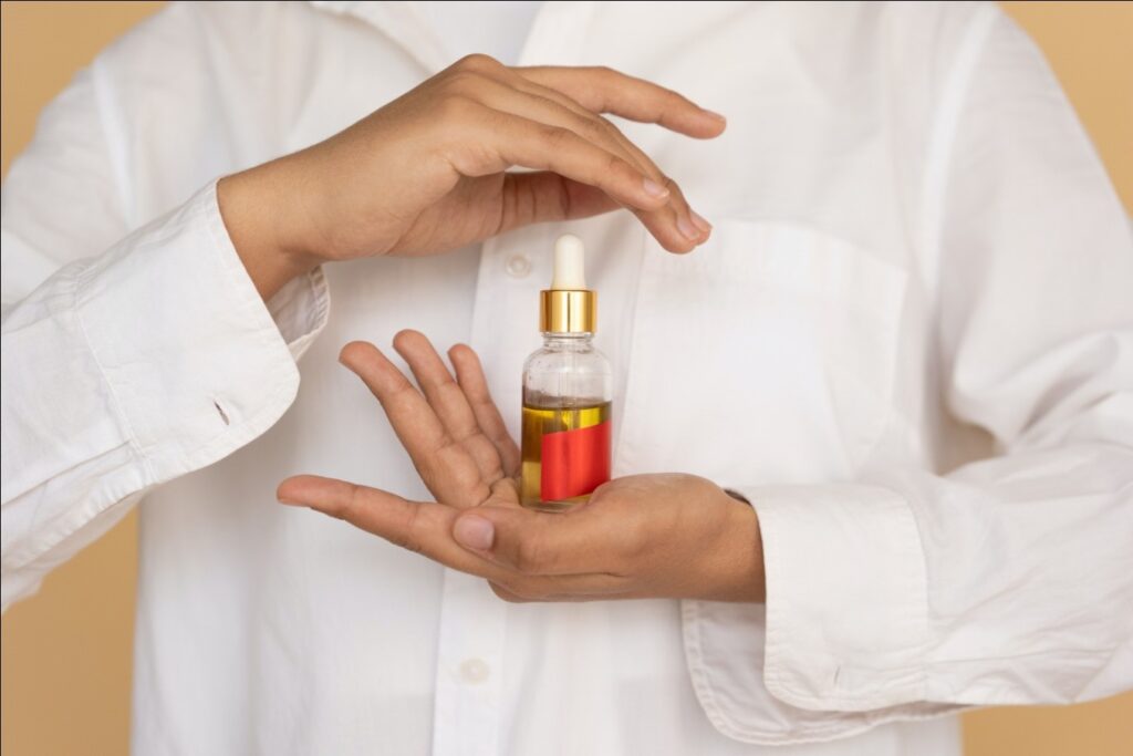 A woman holding a bottle of essential oils