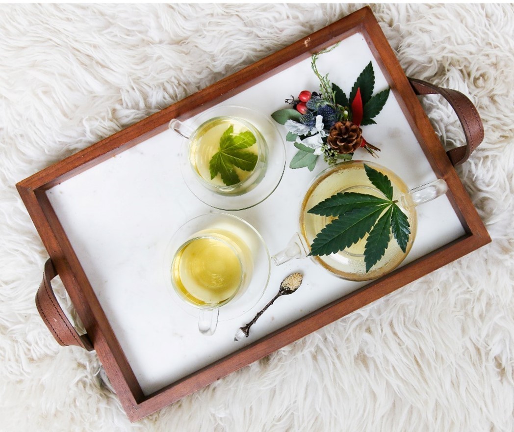 a weed tray with cannabis oil in jar and flowers