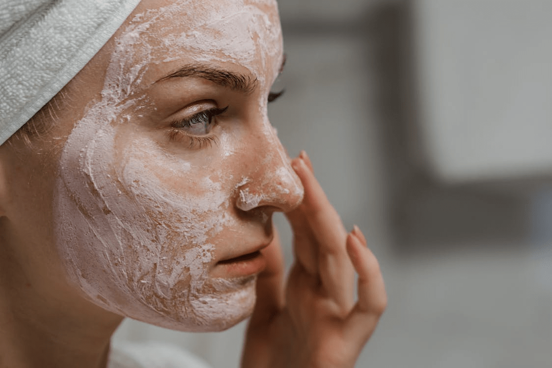  A Close-up Photo of a Woman Applying Facial Cream