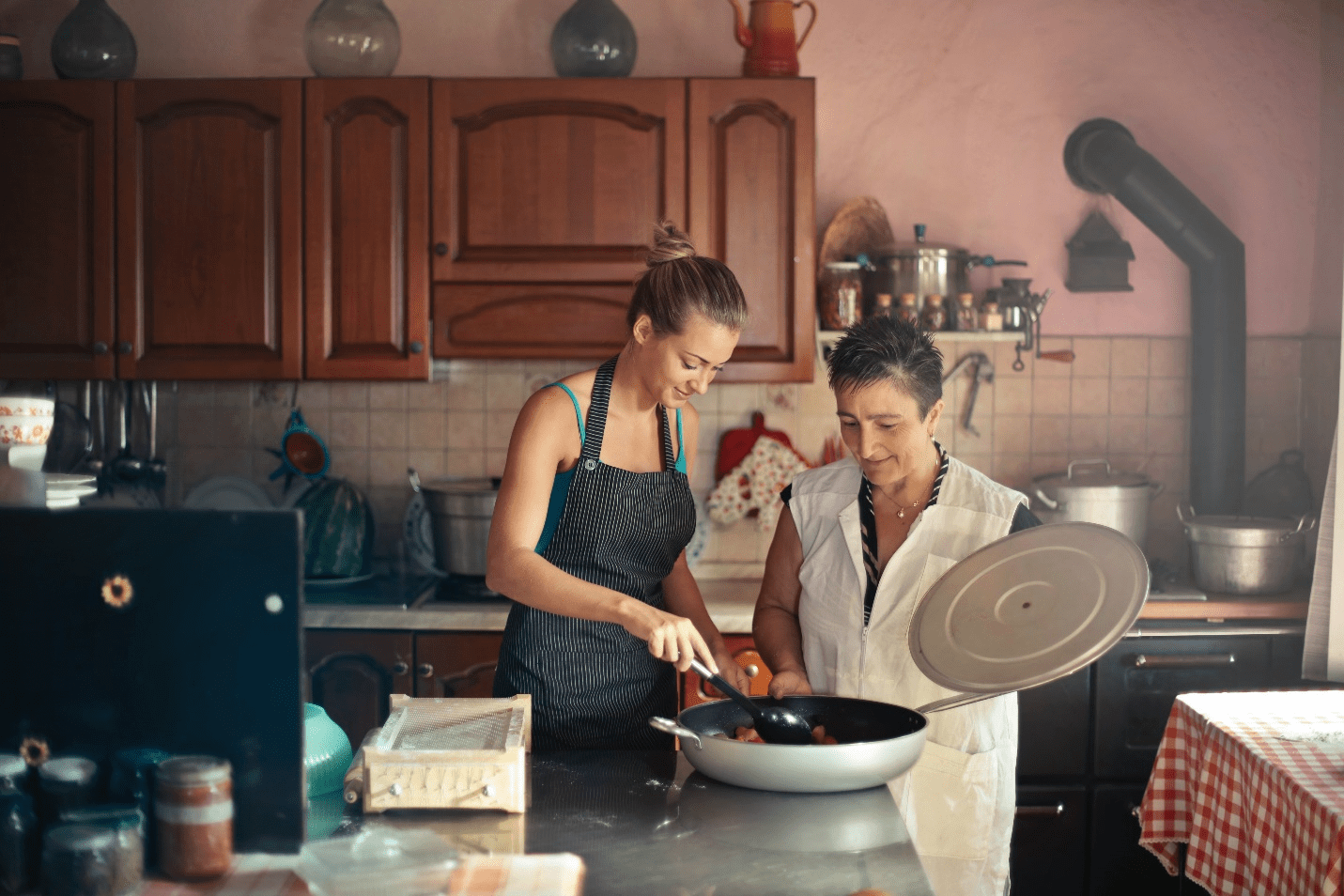 Two women cooking food in the kitchen