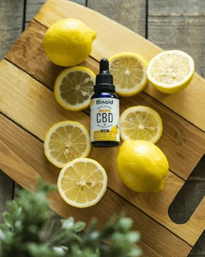 a vial and lemons on a cutting board