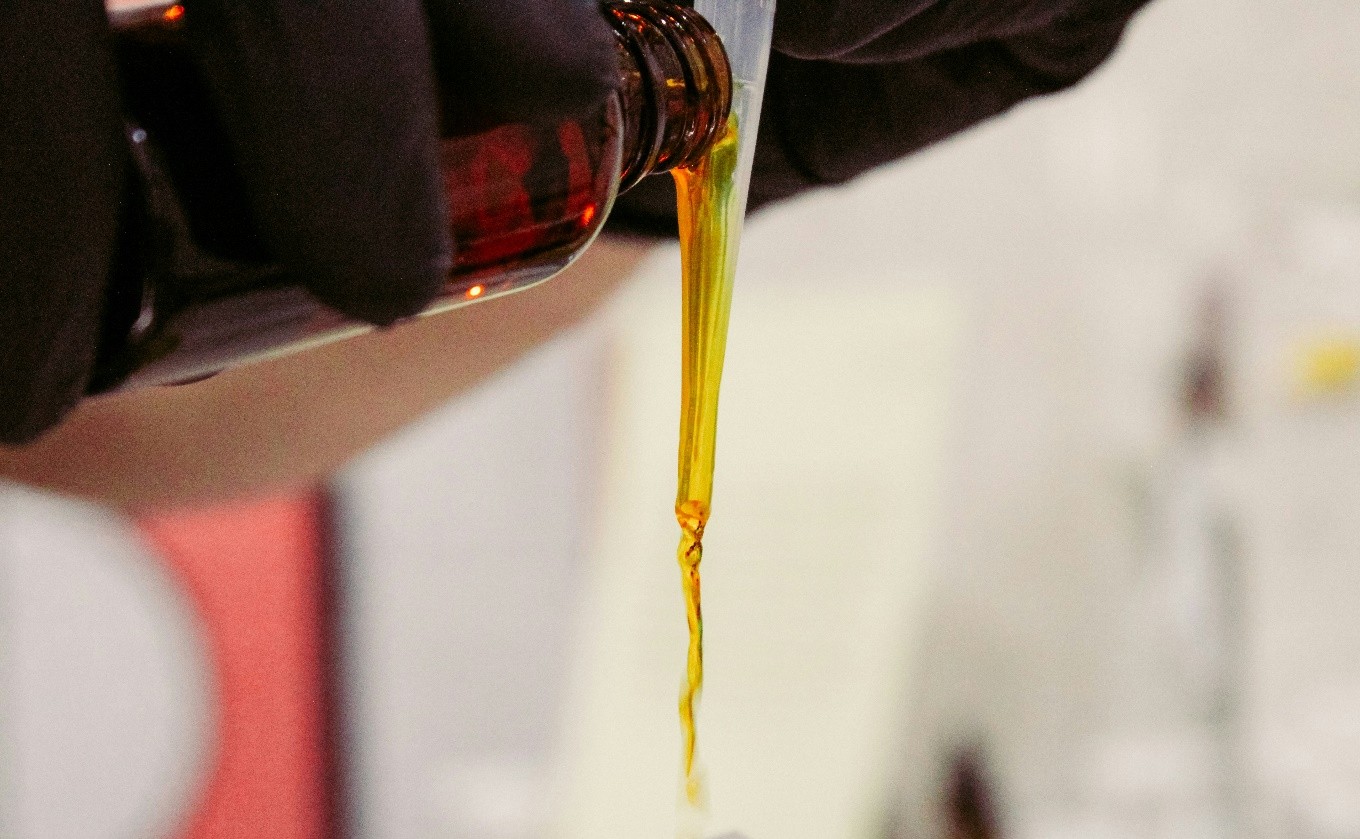 person dripping liquid from the bottle
