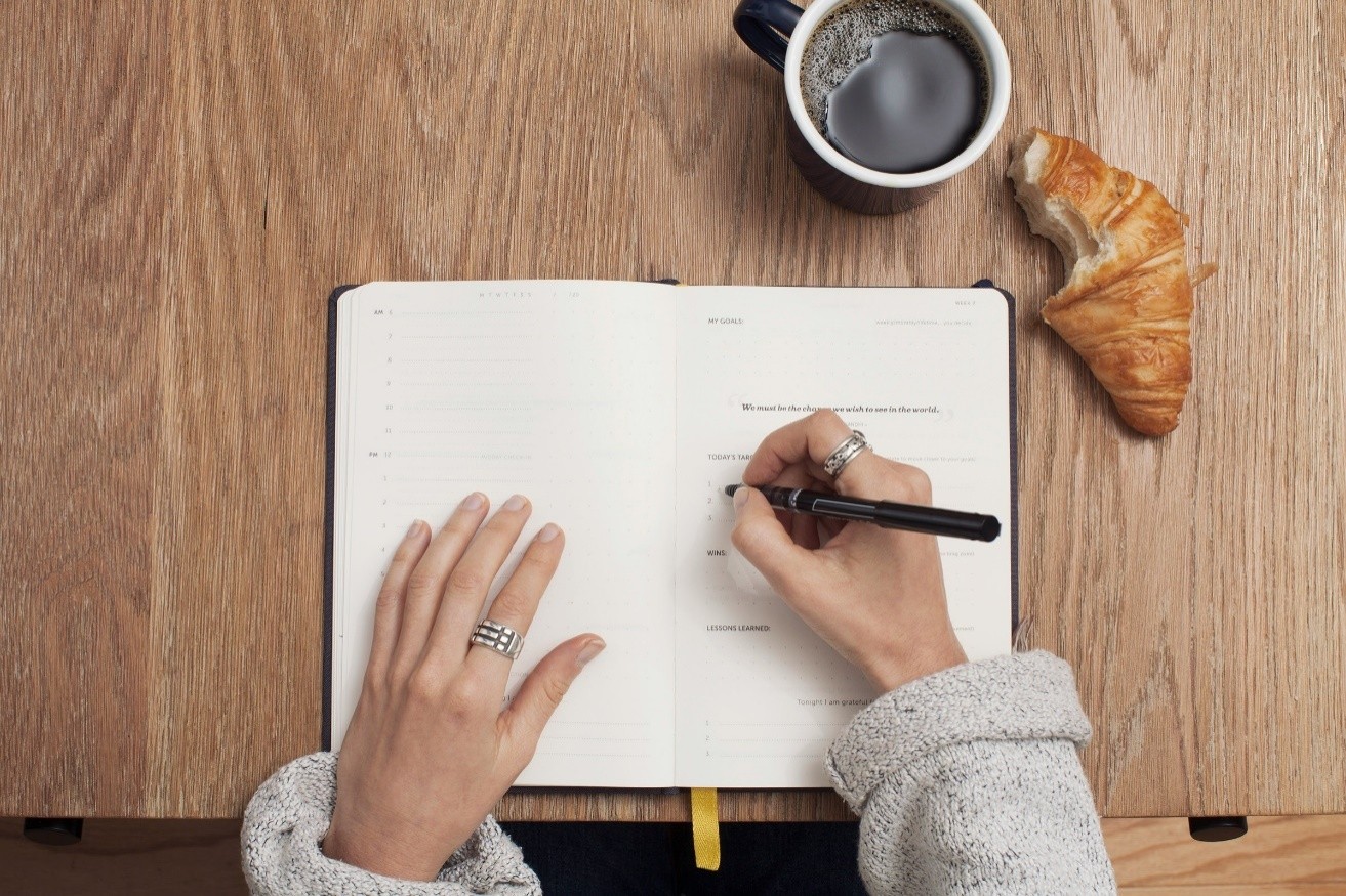 a person writing in a notebook