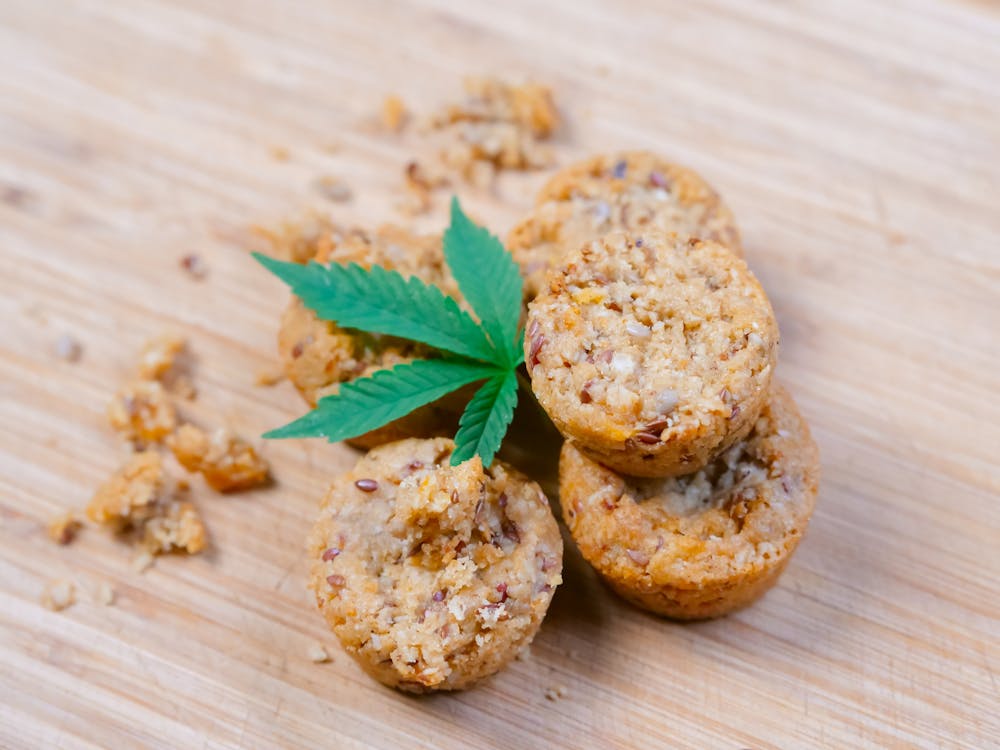 Baked muffins garnished with cannabis leaves