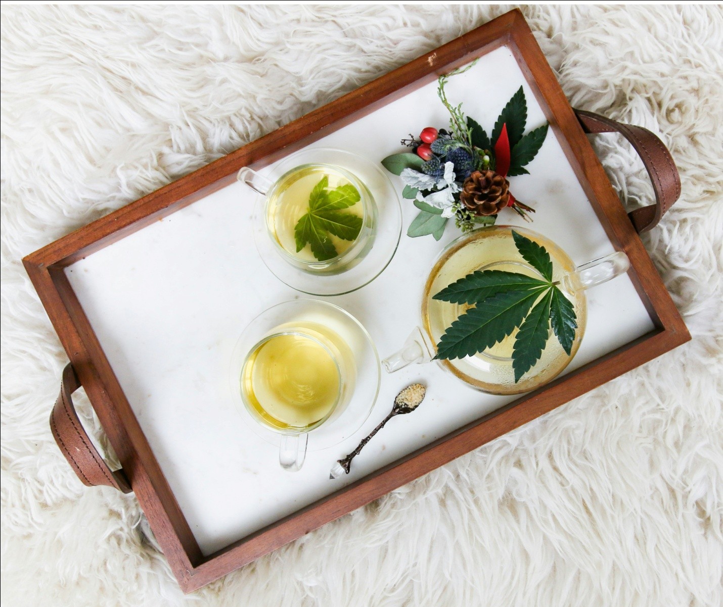 a rectangular wooden tray with teacups