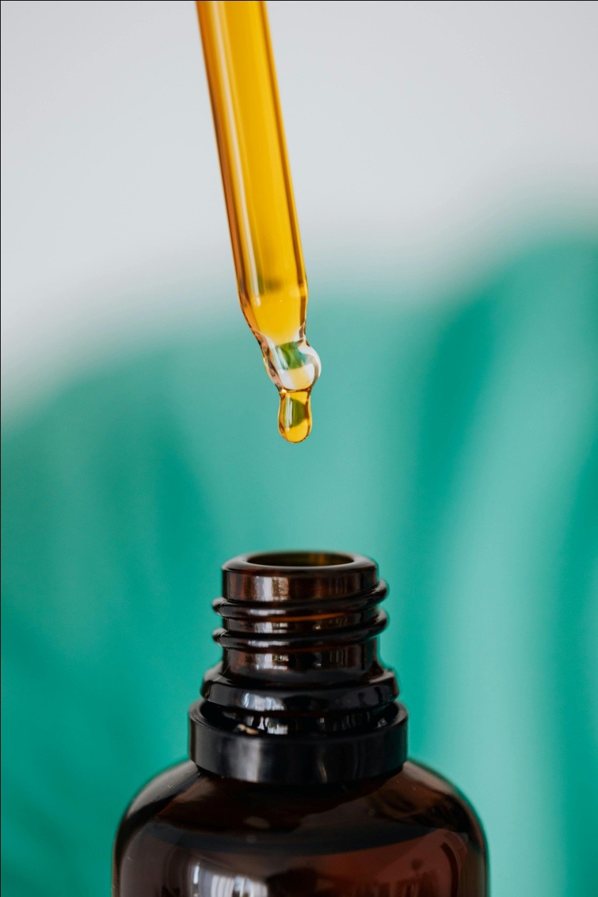 a dropper dropping liquid in a bottle