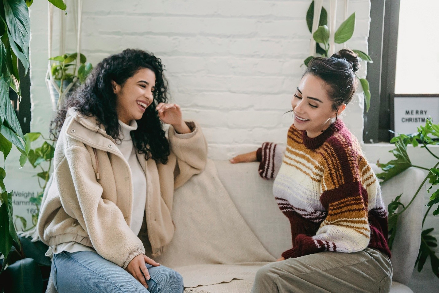 two women sitting on a couch