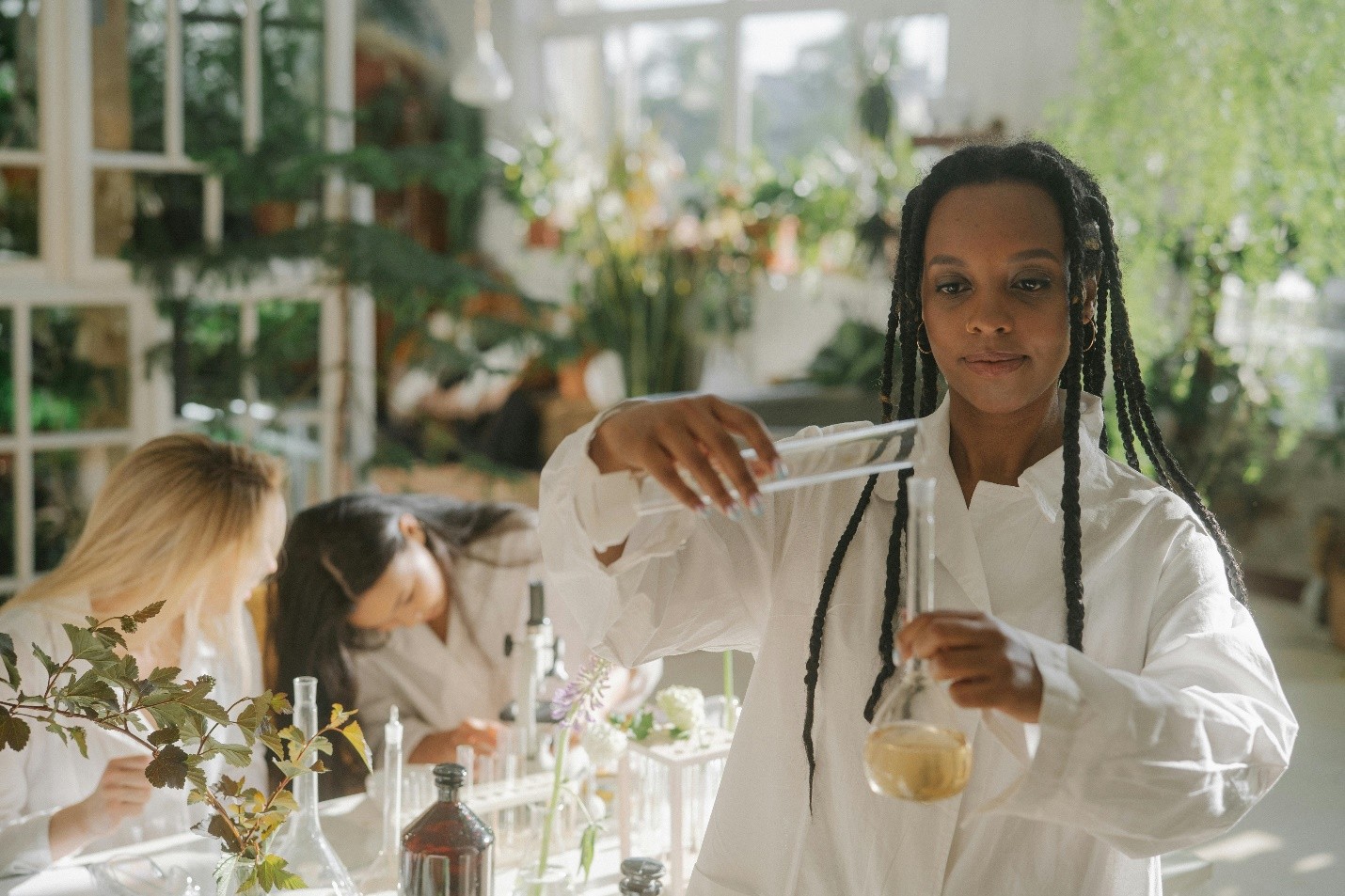 a woman wearing a white lab coat in a lab