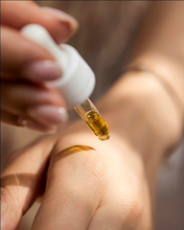 An image of a person holding a dropper   