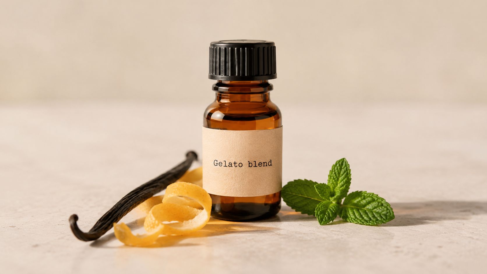 A brown glass apothecary bottle labeled Gelato blend with vanilla bean, lemon zest, and mint leaves nearby.